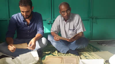 Mauro Nobili and Dr. Mohamed Diagayete (Ahmad Baba Institute, Timbuktu Mali) reading Arabic manuscripts in Abidjan, Ivory Coast (Mauro Nobili)